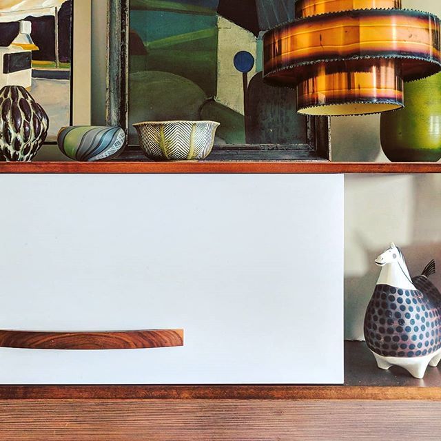 I’ve shared larger areas of my kitchen before but I was compelled to take this little shot this morning as I prepared breakfast.
The vintage art, accessories and handmade pendants, all Scandinavian, to my eye, feature the ever so soft gray cabinetry...