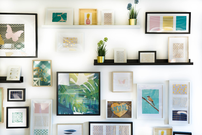 Bright and airy interior photography of different sized picture frames on a white wall