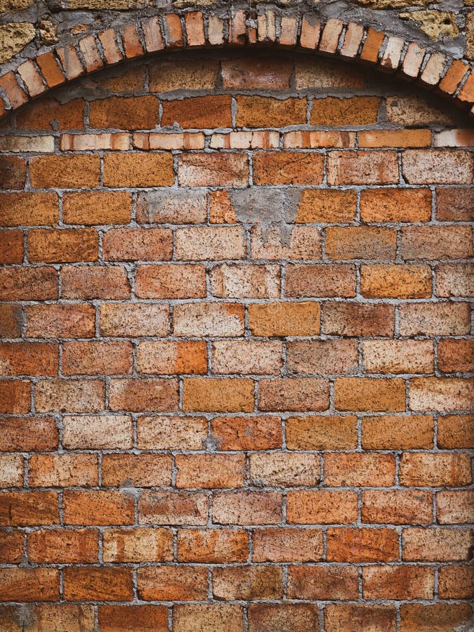 Old red brick wall with an arch royalty free stock photo