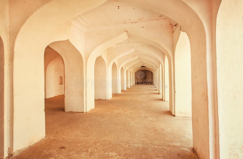 Old stone arches inside the ancient palace in India. stock photos