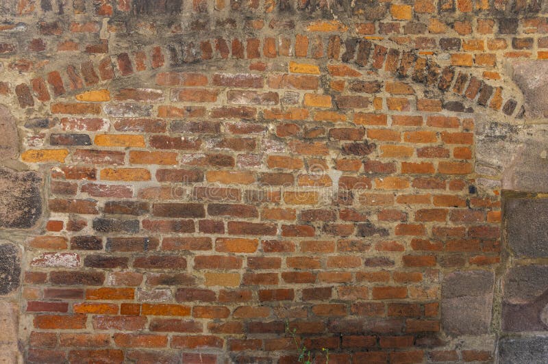 Rustic brick wall with ornamental arch in various sized cutouts as background stock images